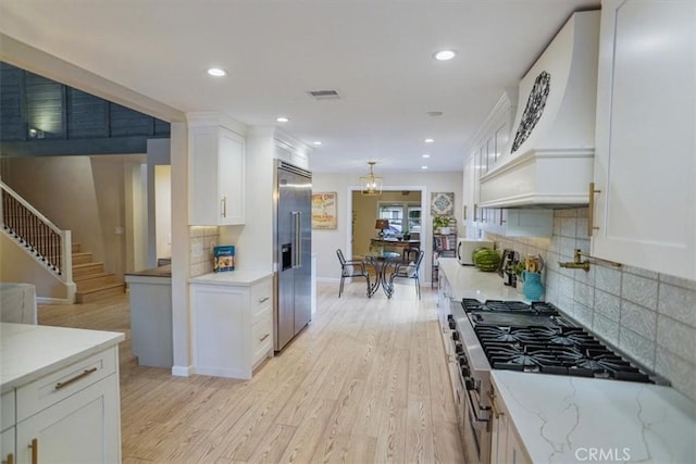 10624 Nevada Ave, Chatsworth, CA 91311 - kitchen featuring built in fridge, white cabinets, light wood-type flooring, recessed lighting, and decorative backsplash