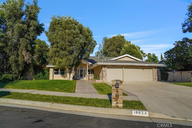 10624 Nevada Ave, Chatsworth, CA 91311 - ranch-style home with a garage, driveway, and stone siding