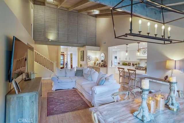 10624 Nevada Ave, Chatsworth, CA 91311 - living room featuring a high ceiling, wood finished floors, stairs, and beam ceiling