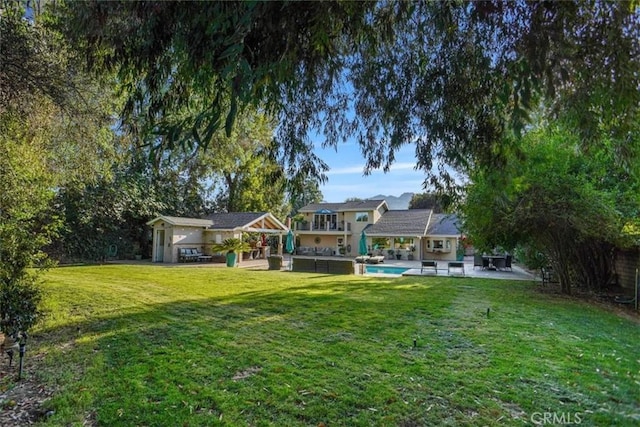 10624 Nevada Ave, Chatsworth, CA 91311 - view of grassy yard featuring a patio area and an outdoor pool