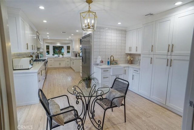 10624 Nevada Ave, Chatsworth, CA 91311 - dining area featuring light wood-style flooring, a chandelier, and recessed lighting