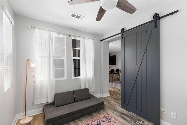 5 Zacate St, Rancho Mission Viejo, CA 92694 - unfurnished room featuring a barn door, ceiling fan, wood finished floors, and plenty of natural light