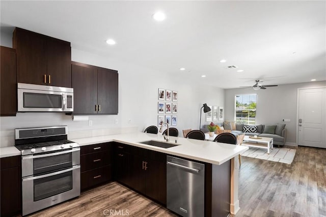 5 Zacate St, Rancho Mission Viejo, CA 92694 - kitchen with stainless steel appliances, a peninsula, light countertops, a ceiling fan, and recessed lighting