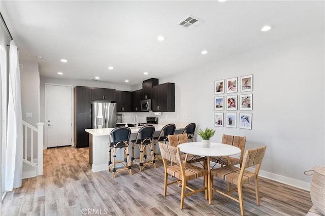 5 Zacate St, Rancho Mission Viejo, CA 92694 - dining room with light wood finished floors, recessed lighting, and stairs