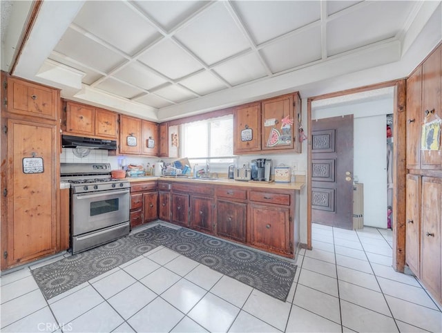 13572 Sutter Dr, Westminster, CA 92683 - kitchen featuring stainless steel gas stove, under cabinet range hood, coffered ceiling, light countertops, and brown cabinetry