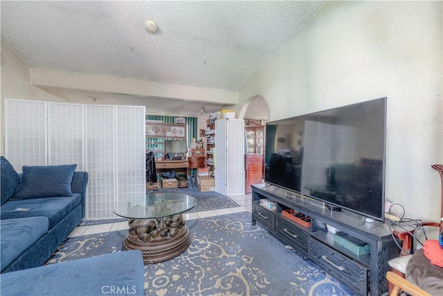 13572 Sutter Dr, Westminster, CA 92683 - living room featuring arched walkways, a textured ceiling, tile patterned flooring, and lofted ceiling