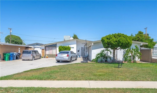 13572 Sutter Dr, Westminster, CA 92683 - view of front of house featuring a front lawn, stucco siding, and concrete driveway