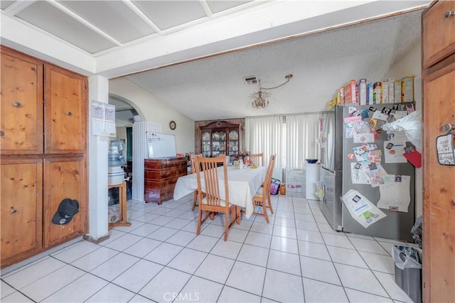 13572 Sutter Dr, Westminster, CA 92683 - dining area with arched walkways, light tile patterned flooring, and a textured ceiling