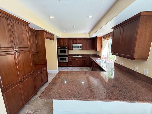 11737 Lois Ct, Granada Hills, CA 91344 - kitchen featuring stainless steel appliances, dark stone countertops, light tile patterned floors, recessed lighting, and a peninsula