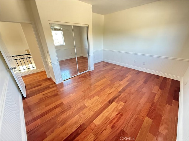 11737 Lois Ct, Granada Hills, CA 91344 - unfurnished bedroom with wood finished floors, a closet, and a wainscoted wall