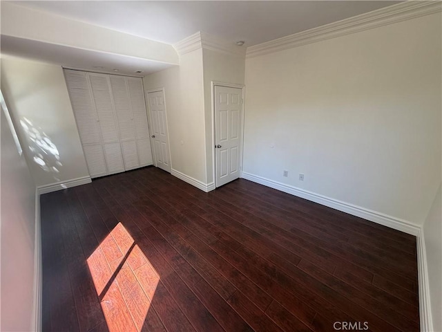 11737 Lois Ct, Granada Hills, CA 91344 - unfurnished bedroom featuring dark wood-type flooring, ornamental molding, and a closet