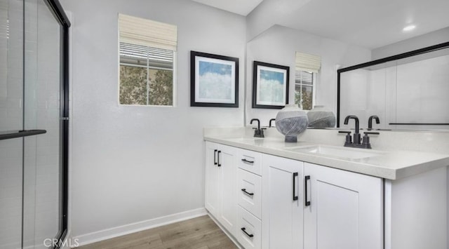 32739 Crystal Cove Ct, Winchester, CA 92596 - bathroom featuring wood finished floors, double vanity, a stall shower, and recessed lighting