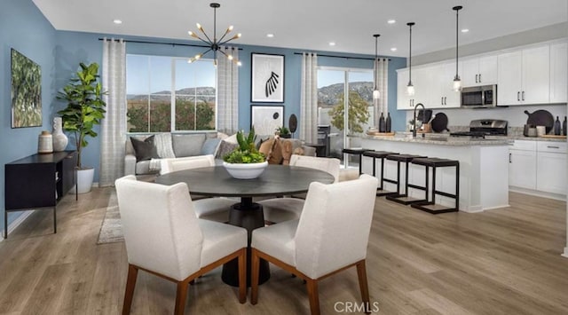 32739 Crystal Cove Ct, Winchester, CA 92596 - dining space featuring light wood-type flooring, recessed lighting, a chandelier, and a mountain view