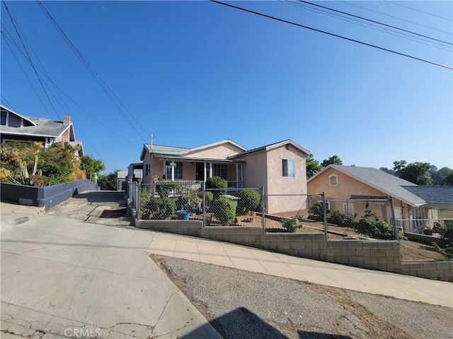 6162 Annan Way, Los Angeles, CA 90042 - bungalow-style house with stucco siding and a fenced front yard