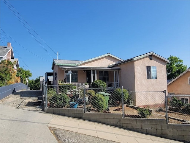 6162 Annan Way, Los Angeles, CA 90042 - view of front facade featuring a porch, stucco siding, a fenced front yard, and a gate