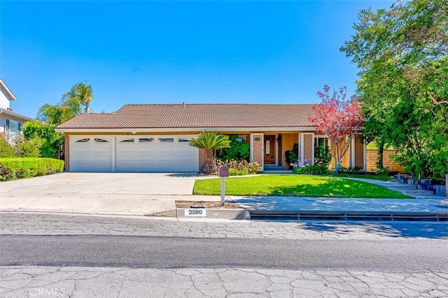 2580 Crown Way, Fullerton, CA 92833 - view of front of home featuring a tiled roof, driveway, a garage, a front lawn, and stucco siding