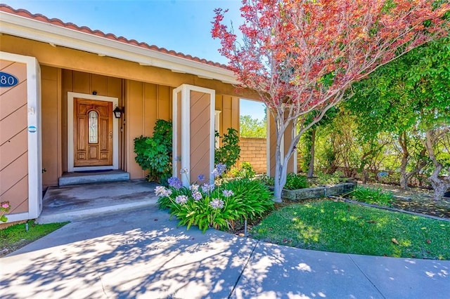 2580 Crown Way, Fullerton, CA 92833 - view of exterior entry featuring a tiled roof, board and batten siding, and driveway