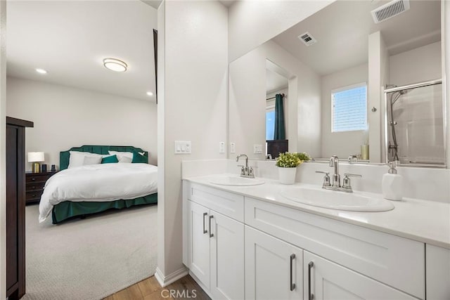 247 Lockhart Way, West Covina, CA 91790 - ensuite bathroom featuring double vanity, wood finished floors, a shower with door, and recessed lighting
