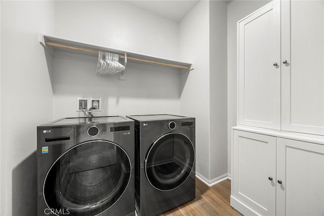 247 Lockhart Way, West Covina, CA 91790 - laundry area featuring separate washer and dryer, light wood-type flooring, and cabinet space