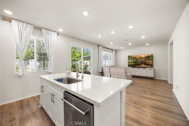 247 Lockhart Way, West Covina, CA 91790 - kitchen featuring stainless steel dishwasher, light wood-style flooring, white cabinets, a center island with sink, and light countertops