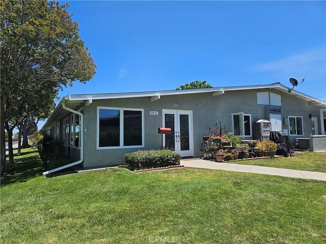 1402 Golden Rain Rd Unit 55G, Seal Beach, CA 90740 - view of front of home with stucco siding, a front lawn, and french doors