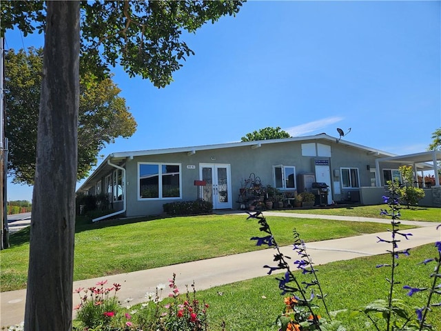 1402 Golden Rain Rd Unit 55G, Seal Beach, CA 90740 - view of front of home with stucco siding, french doors, and a front yard