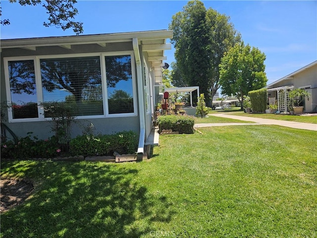 1402 Golden Rain Rd Unit 55G, Seal Beach, CA 90740 - view of property exterior featuring a lawn and stucco siding