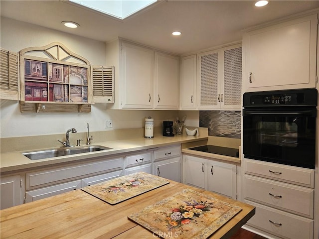 1402 Golden Rain Rd Unit 55G, Seal Beach, CA 90740 - kitchen featuring black appliances, light countertops, white cabinetry, recessed lighting, and backsplash