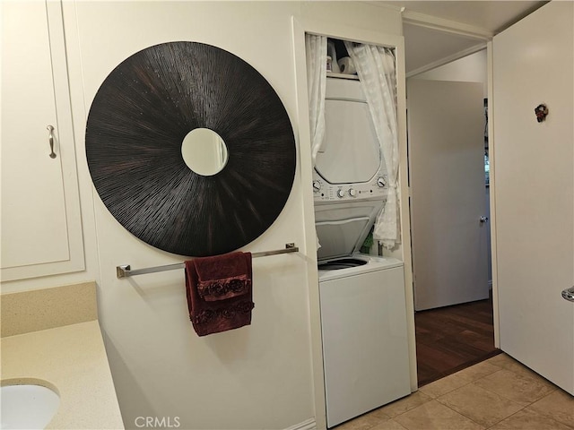 1402 Golden Rain Rd Unit 55G, Seal Beach, CA 90740 - washroom with stacked washer / drying machine and light tile patterned floors