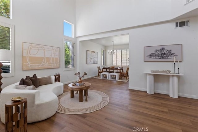 14080 Crestline Pl, Rancho Cucamonga, CA 91739 - living area featuring wood finished floors, a high ceiling, and a chandelier