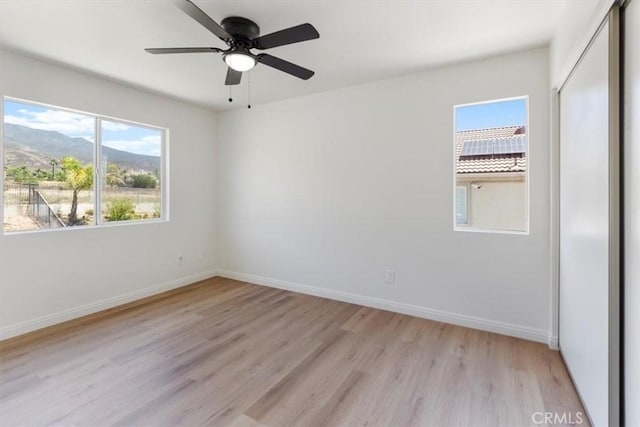 14080 Crestline Pl, Rancho Cucamonga, CA 91739 - spare room with light wood-style floors, a ceiling fan, and a mountain view