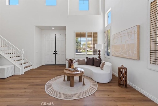 14080 Crestline Pl, Rancho Cucamonga, CA 91739 - living room with wood finished floors, healthy amount of natural light, a towering ceiling, and stairs