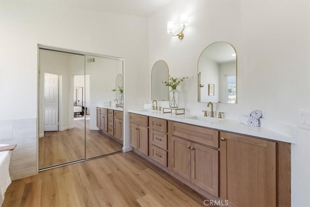 14080 Crestline Pl, Rancho Cucamonga, CA 91739 - full bathroom featuring double vanity, wood finished floors, and a bathtub