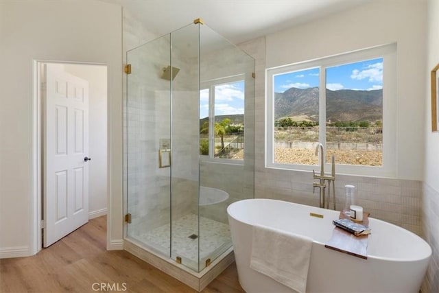 14080 Crestline Pl, Rancho Cucamonga, CA 91739 - bathroom with a stall shower, tile walls, wood finished floors, a mountain view, and a soaking tub