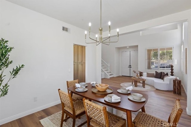 14080 Crestline Pl, Rancho Cucamonga, CA 91739 - dining room featuring stairway, light wood-style floors, and a chandelier