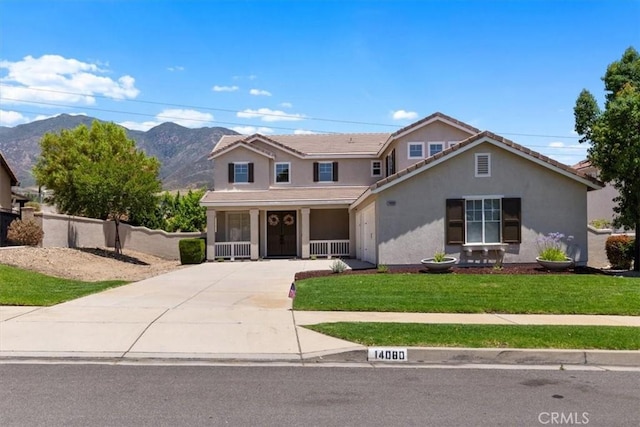14080 Crestline Pl, Rancho Cucamonga, CA 91739 - traditional home featuring concrete driveway, stucco siding, a front lawn, a mountain view, and covered porch