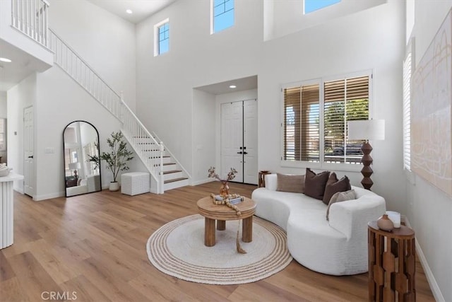 14080 Crestline Pl, Rancho Cucamonga, CA 91739 - living area featuring stairs, a high ceiling, light wood-type flooring, and recessed lighting