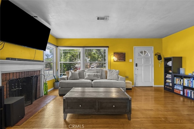 2184 S Towne Ave, Pomona, CA 91766 - living room with wood finished floors and a brick fireplace