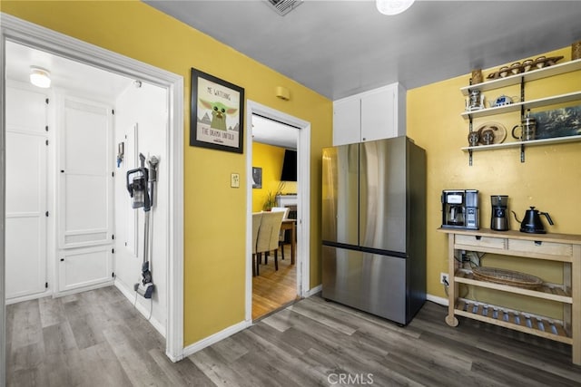 2184 S Towne Ave, Pomona, CA 91766 - kitchen with freestanding refrigerator, wood finished floors, and white cabinetry