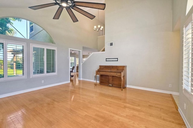 635 Boysenberry Way, Oceanside, CA 92057 - unfurnished living room with healthy amount of natural light, light wood-type flooring, a towering ceiling, and a ceiling fan