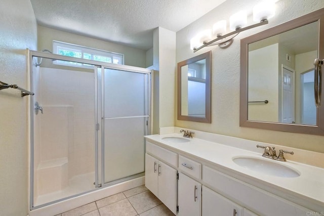 635 Boysenberry Way, Oceanside, CA 92057 - full bathroom featuring a shower stall, double vanity, a textured ceiling, and tile patterned flooring