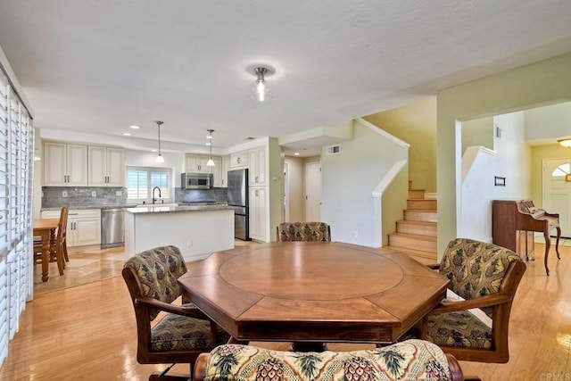635 Boysenberry Way, Oceanside, CA 92057 - dining space with light wood-style flooring, stairway, and recessed lighting