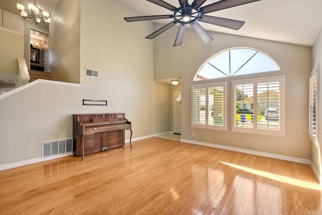 635 Boysenberry Way, Oceanside, CA 92057 - unfurnished living room featuring wood finished floors, a ceiling fan, high vaulted ceiling, and a chandelier
