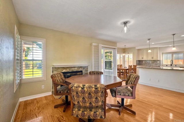 635 Boysenberry Way, Oceanside, CA 92057 - dining area featuring light wood-type flooring, healthy amount of natural light, and a fireplace