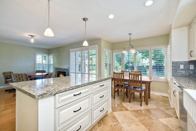 635 Boysenberry Way, Oceanside, CA 92057 - kitchen featuring a lit fireplace, decorative backsplash, pendant lighting, white cabinets, and recessed lighting