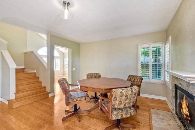 635 Boysenberry Way, Oceanside, CA 92057 - dining space with plenty of natural light, light wood-style flooring, and a fireplace with flush hearth