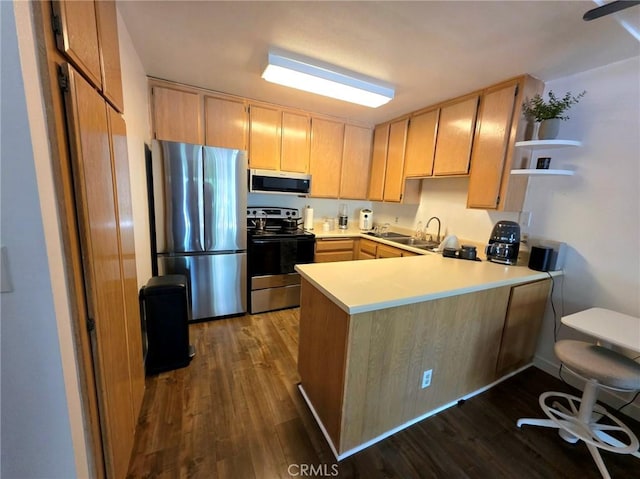 6815 Remmet Ave Unit 217, Canoga Park, CA 91303 - kitchen featuring appliances with stainless steel finishes, a peninsula, dark wood-type flooring, light brown cabinetry, and light countertops