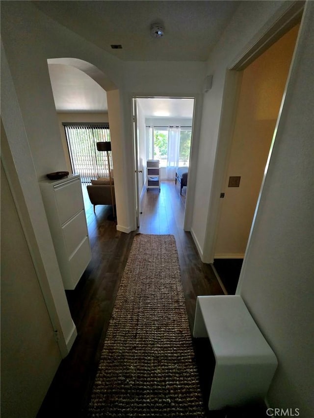 6815 Remmet Ave Unit 217, Canoga Park, CA 91303 - hallway with arched walkways and wood finished floors