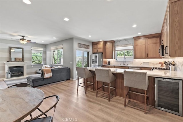 9180 Araujo Ct, Atascadero, CA 93422 - kitchen with beverage cooler, appliances with stainless steel finishes, light countertops, a kitchen breakfast bar, and a peninsula
