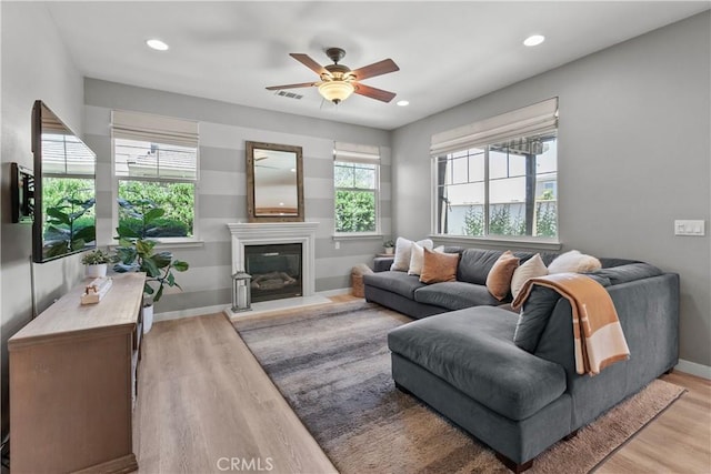 9180 Araujo Ct, Atascadero, CA 93422 - living area with light wood-style flooring, a ceiling fan, recessed lighting, and a glass covered fireplace